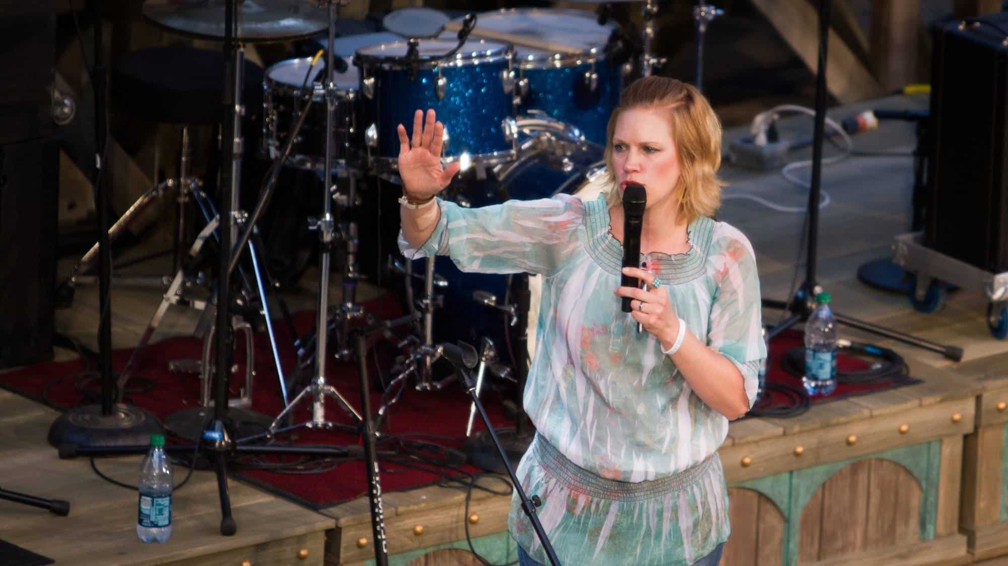 Woman speaking at outdoor event on stage